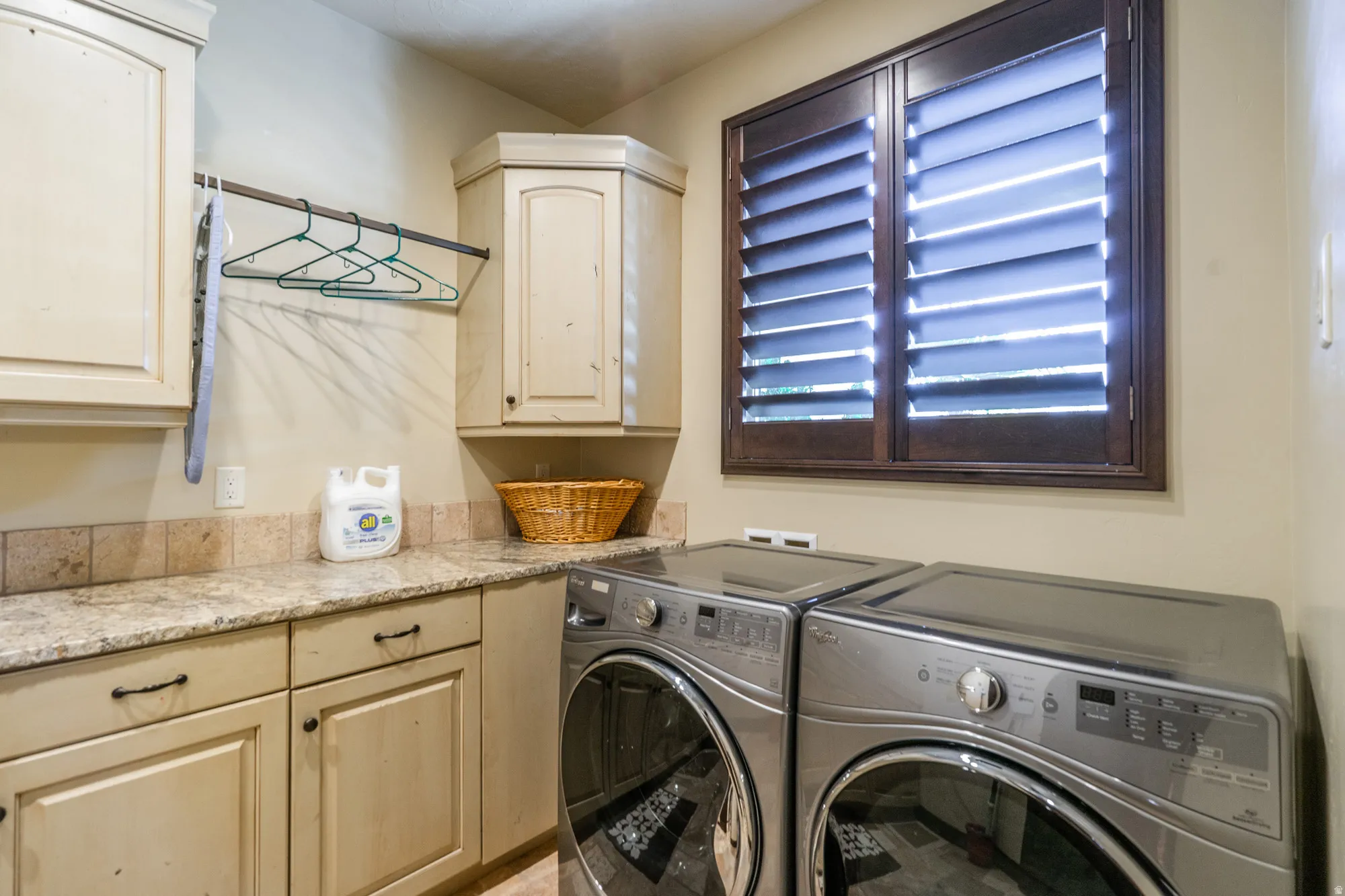 Laundry area with separate washer and dryer and cabinet space