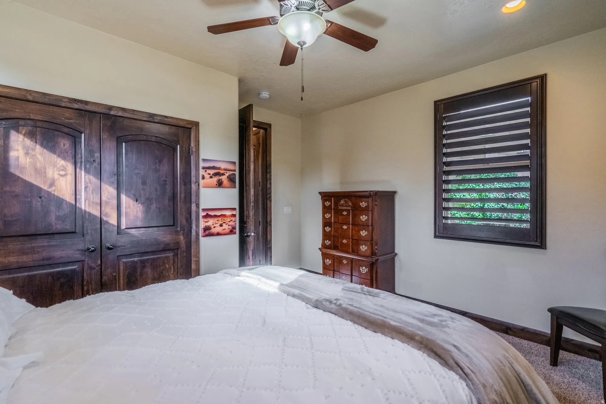 Bedroom featuring ceiling fan and carpet