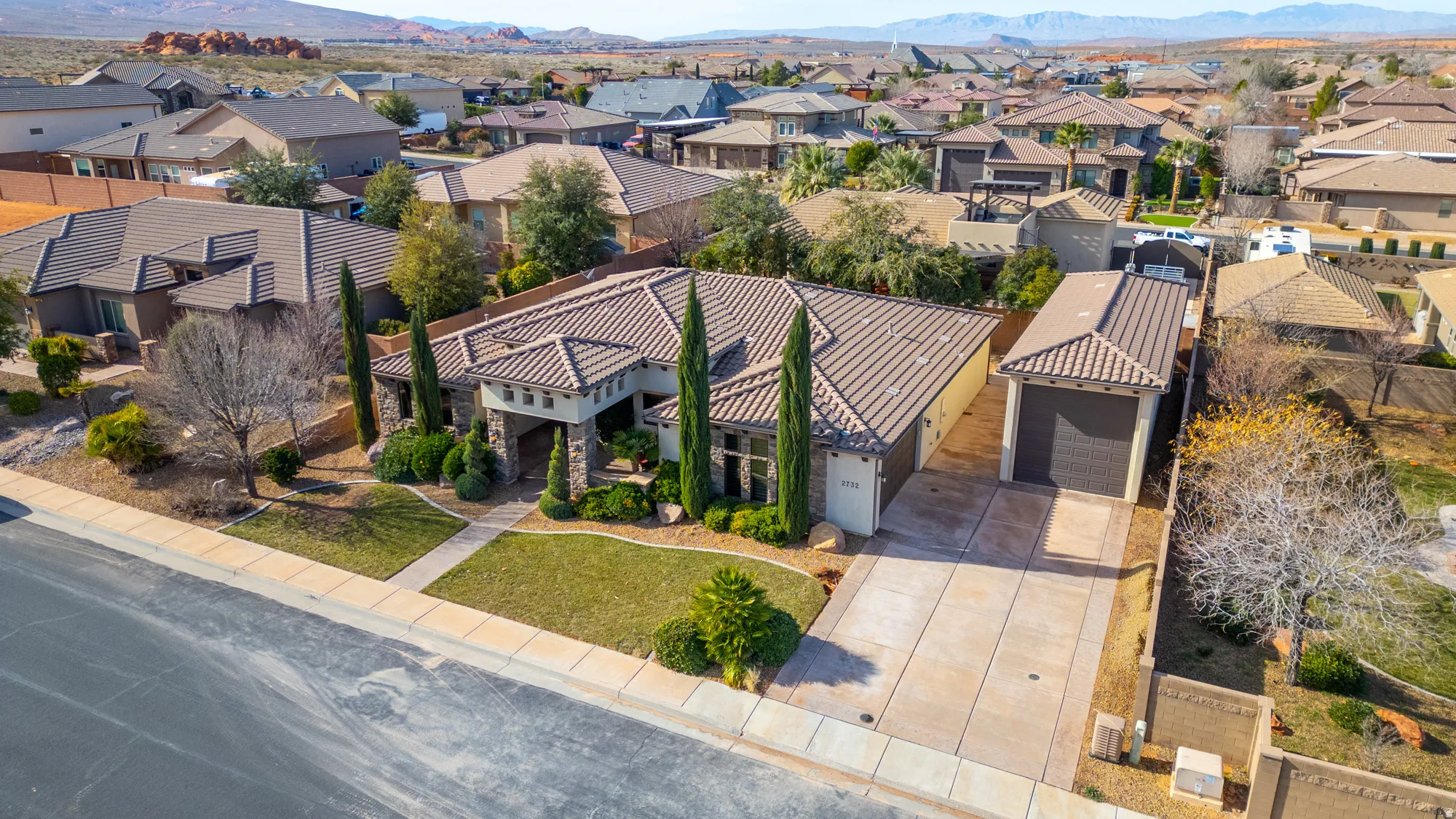 Aerial view of residential area featuring a mountainous background