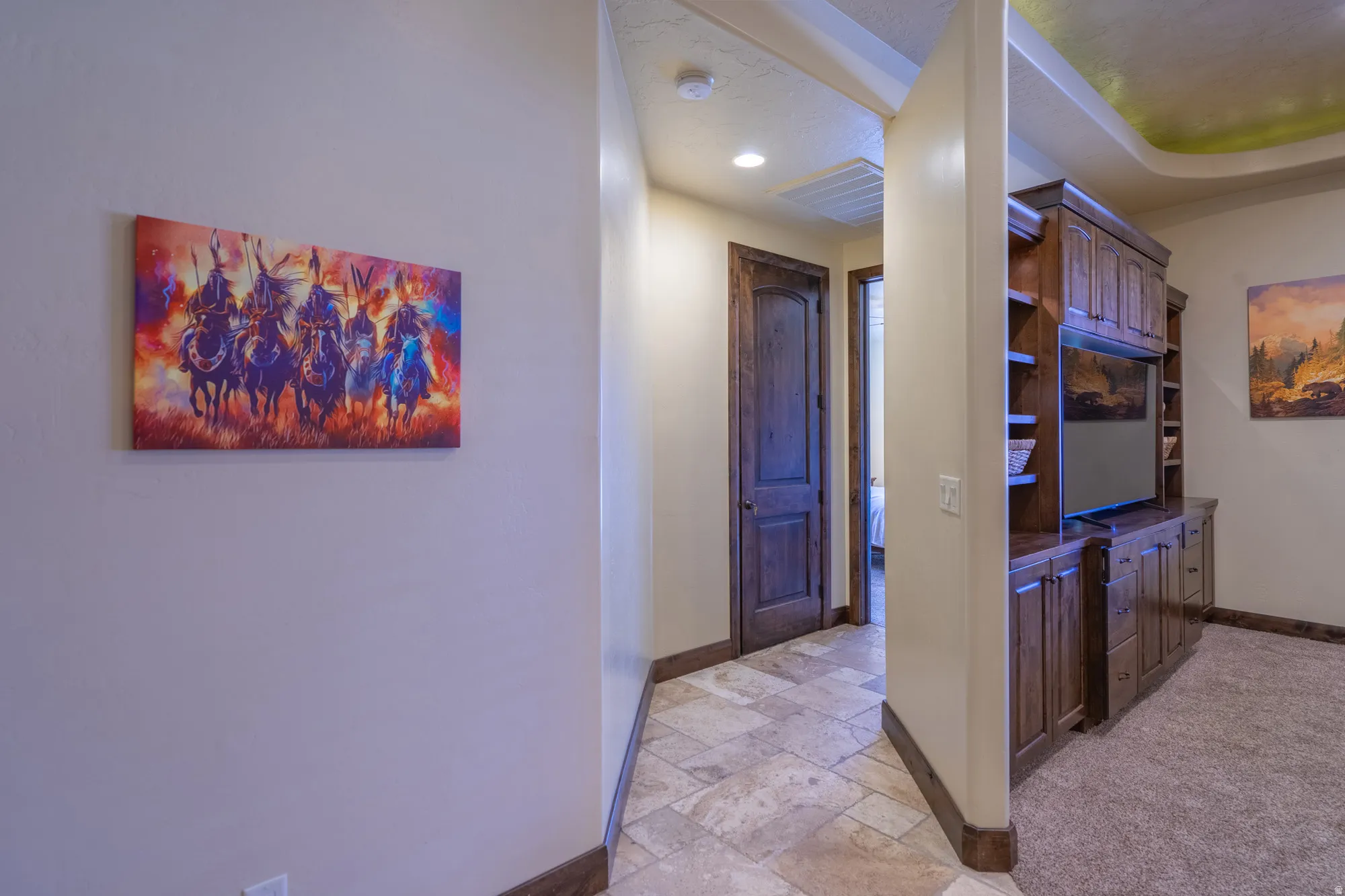 Hallway with stone tile floors and recessed lighting