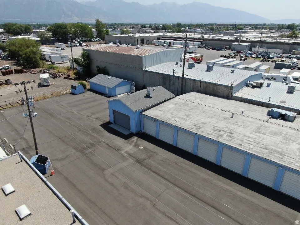 Aerial view of industrial structures and a mountainous background