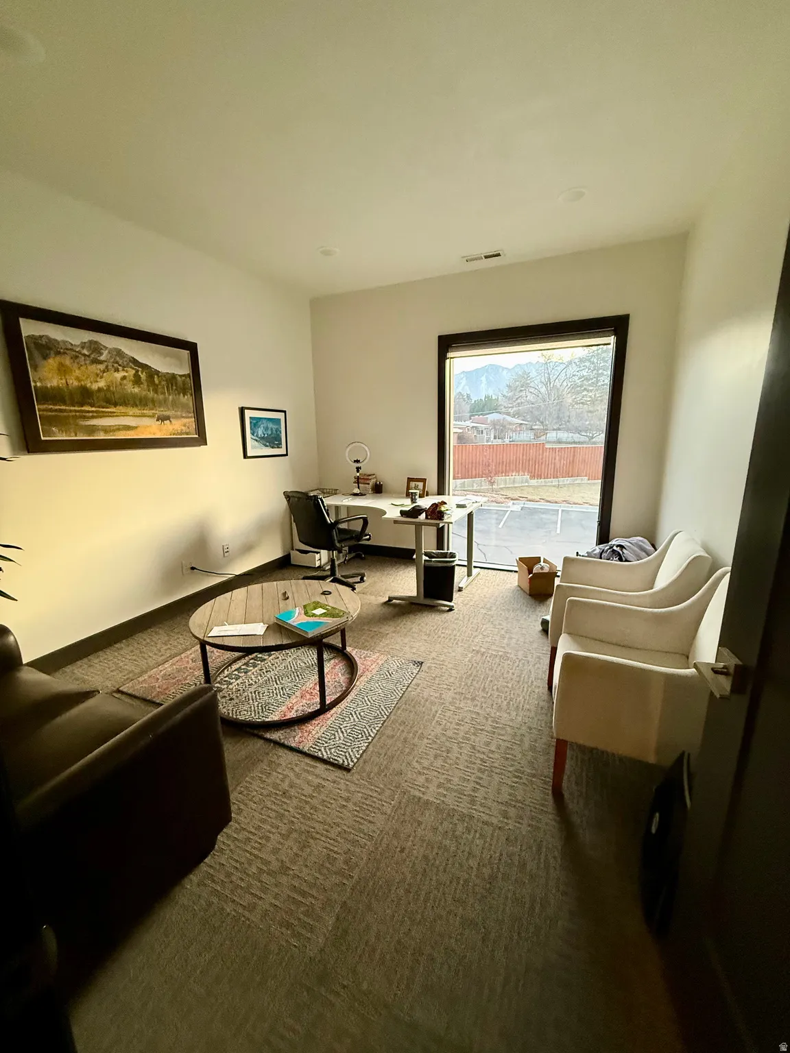 Sitting room featuring carpet flooring and a desk