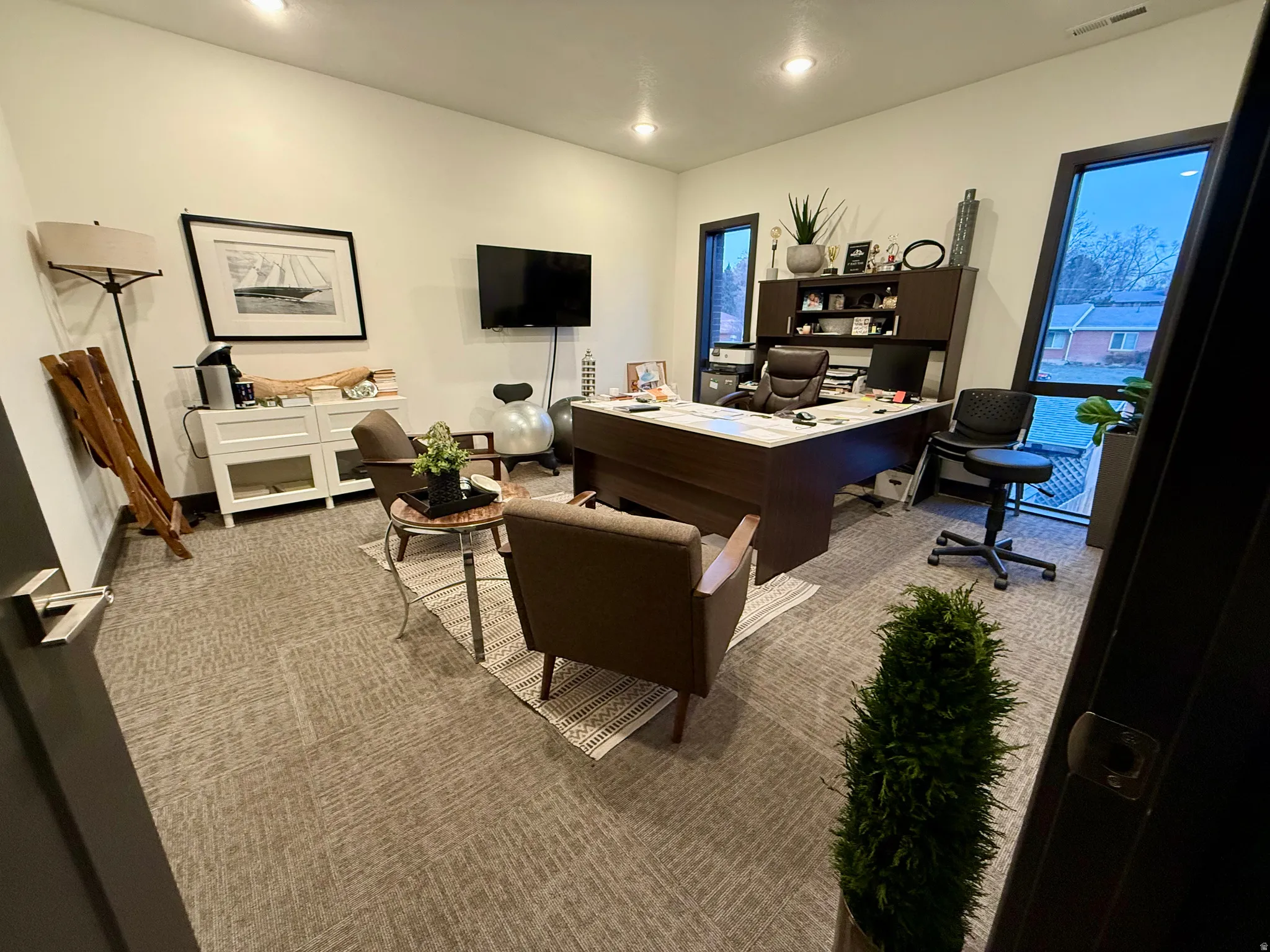 Carpeted office space featuring recessed lighting