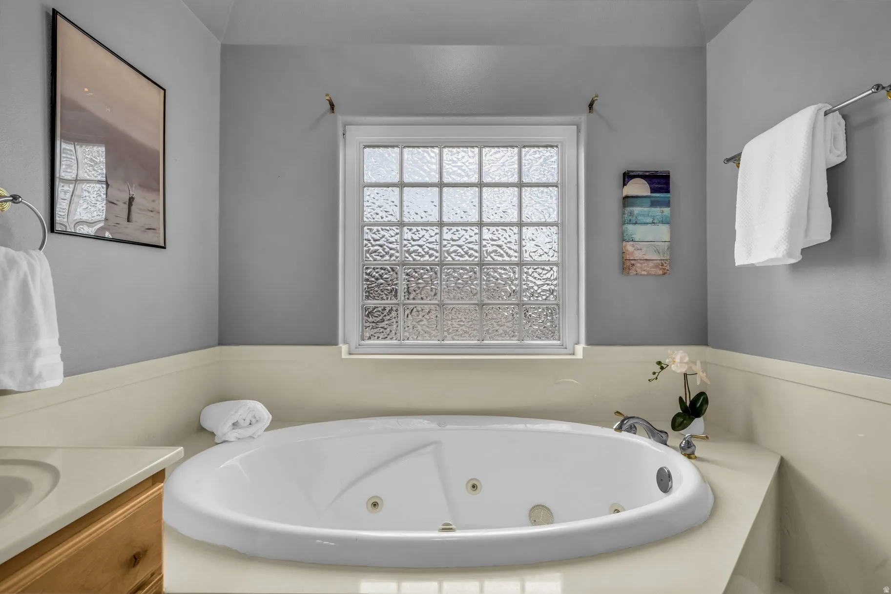 Bathroom with a tub with jets and vanity