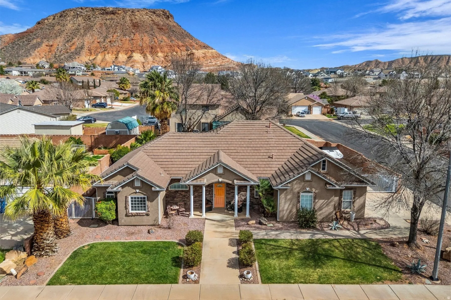 View of front of property with a mountain view, a front lawn, and a residential view