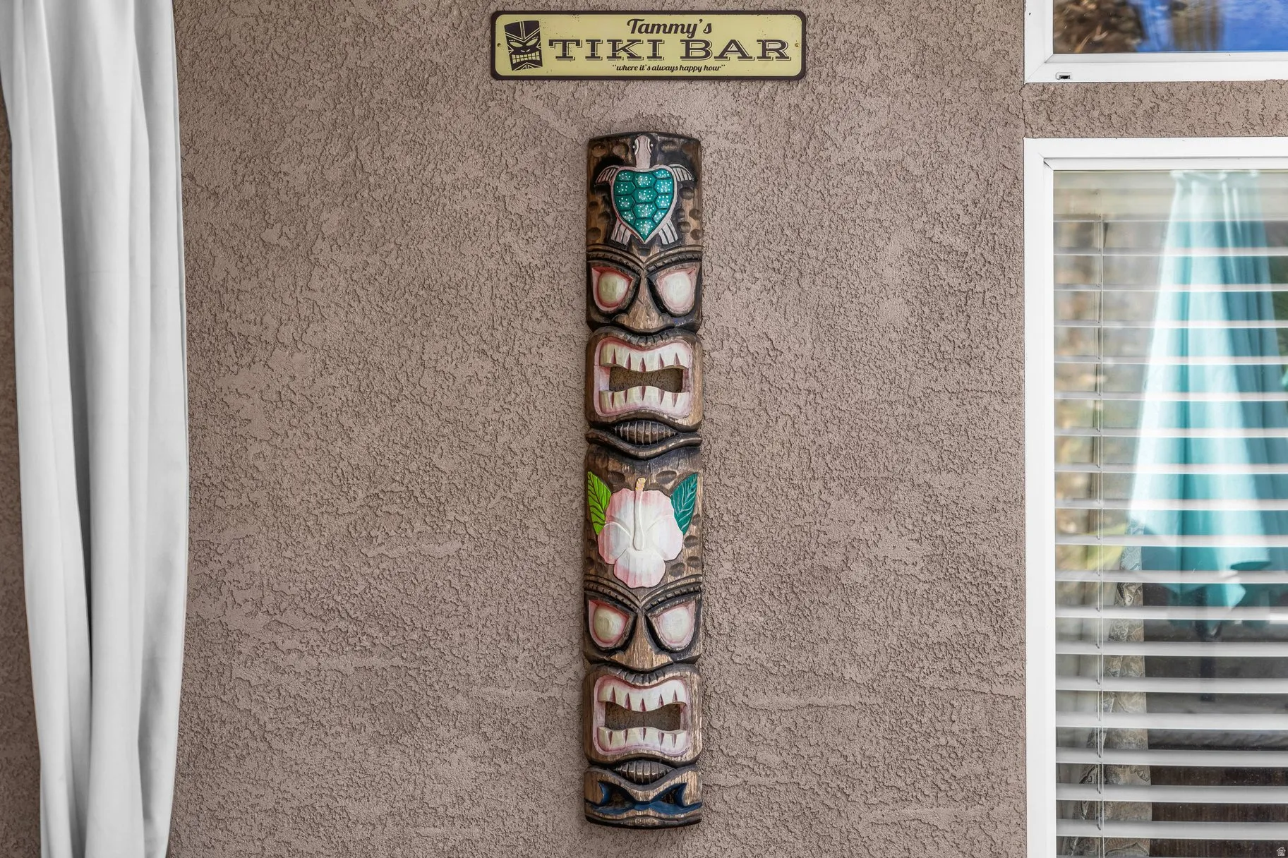 Exterior view of stucco siding and beverage cooler