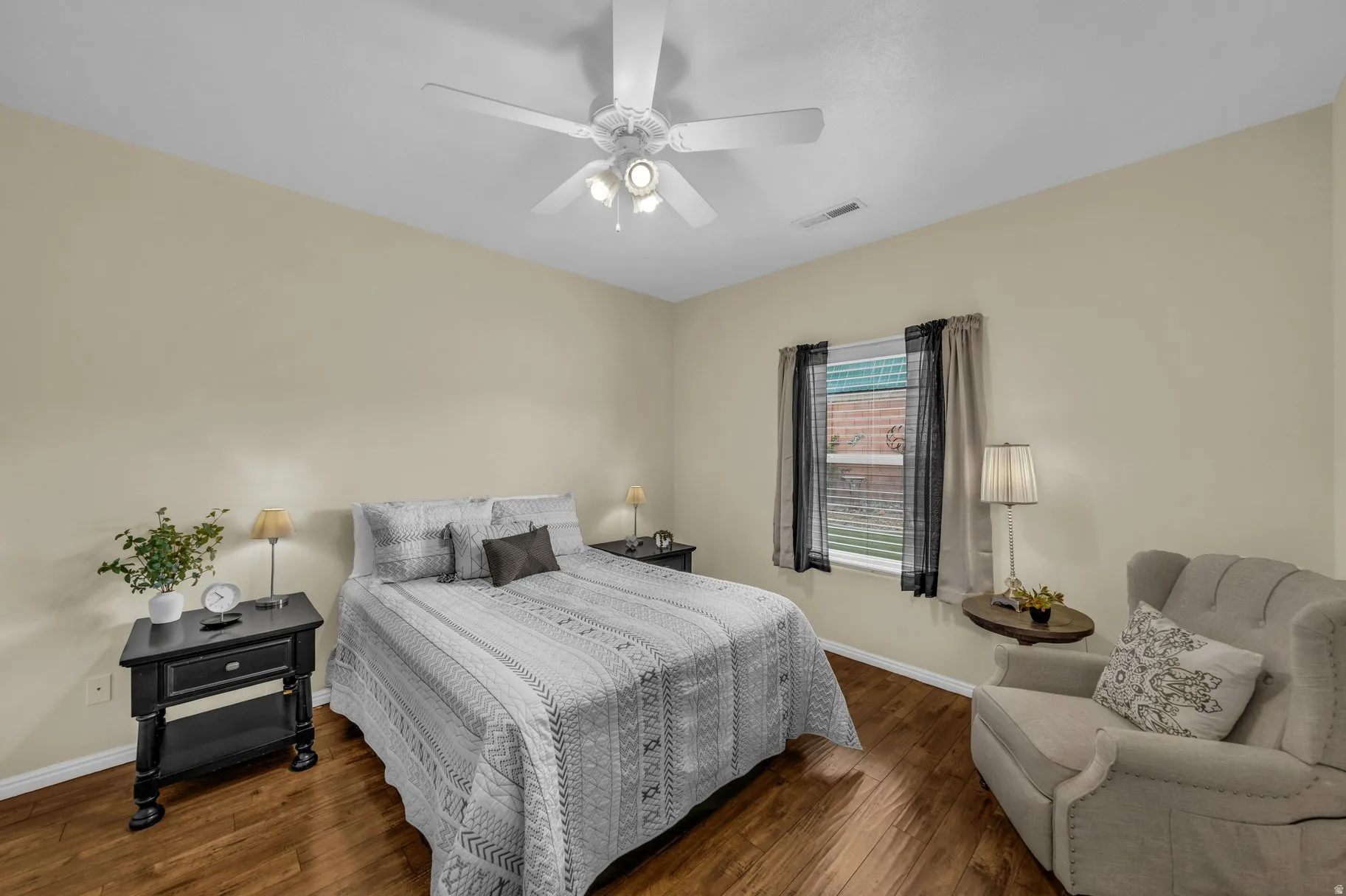 Bedroom with dark wood-style flooring and ceiling fan