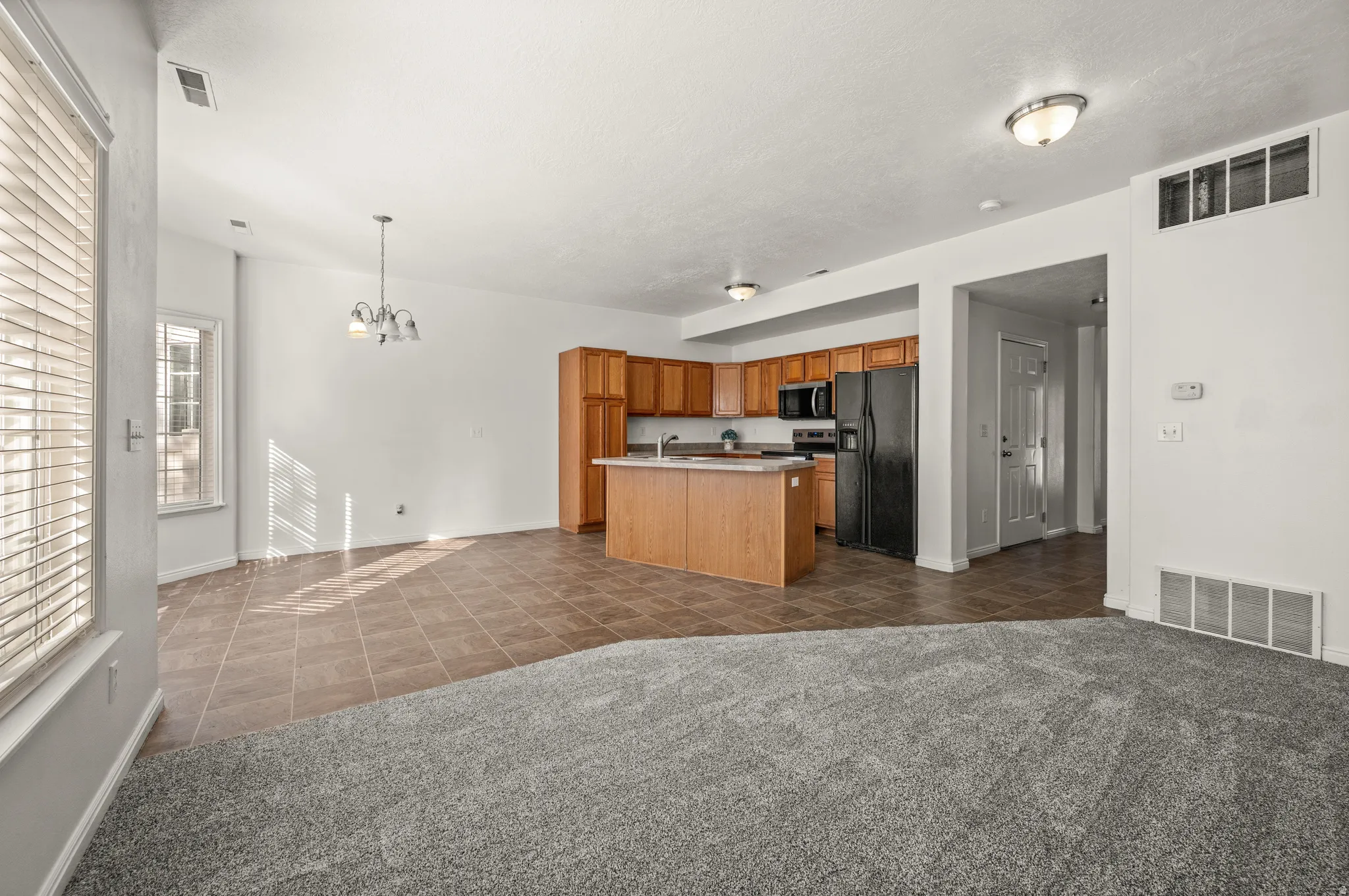 Open concept family room to kitchen and kitchen nook.