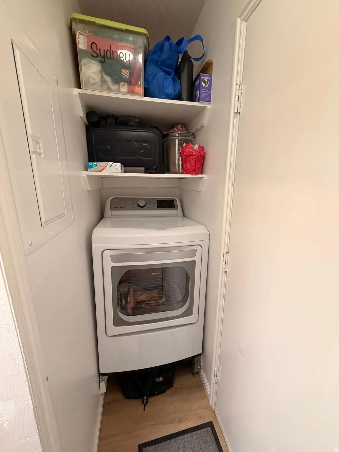 Laundry room with washer / dryer and light wood-style floors
