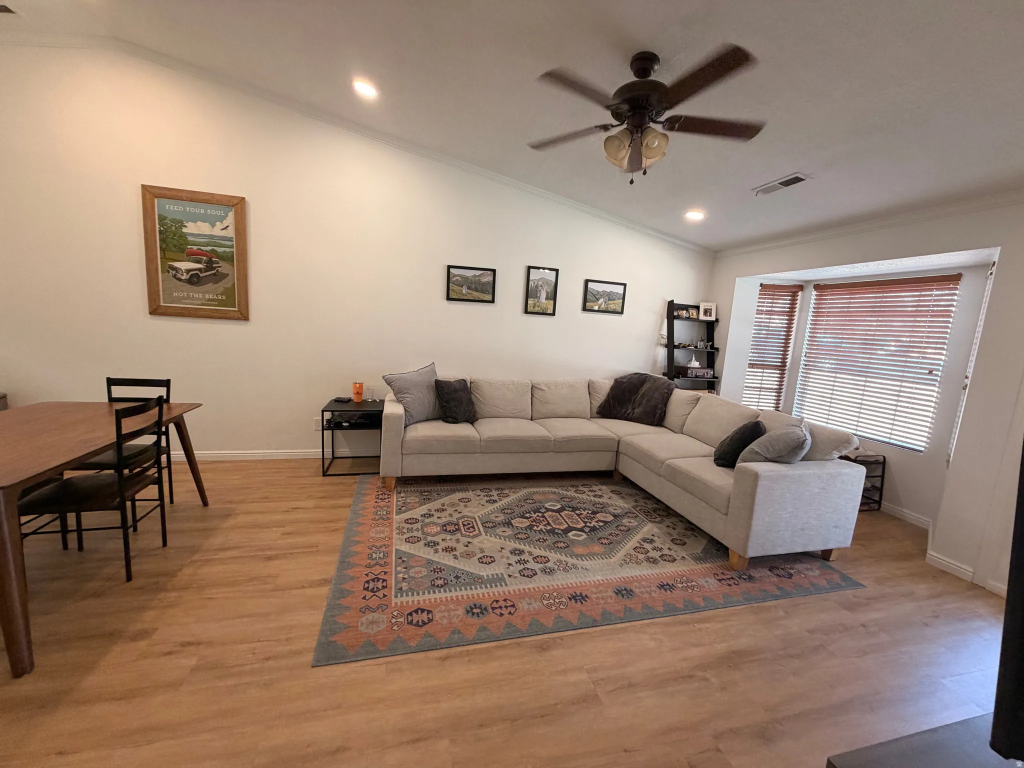 Living room featuring a ceiling fan, recessed lighting, light wood-style floors, and ornamental molding