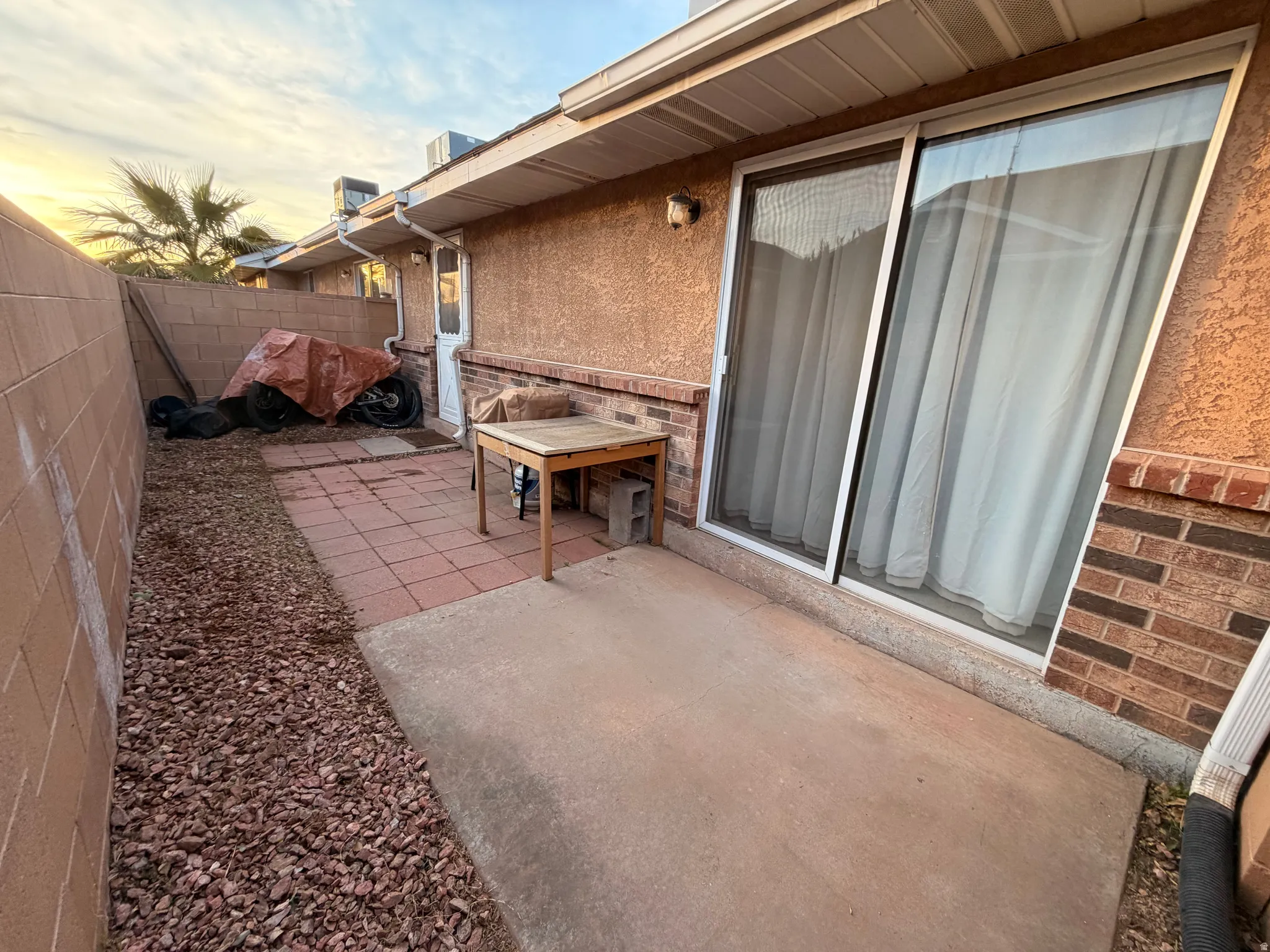 Patio terrace at dusk featuring a patio area and a fenced backyard