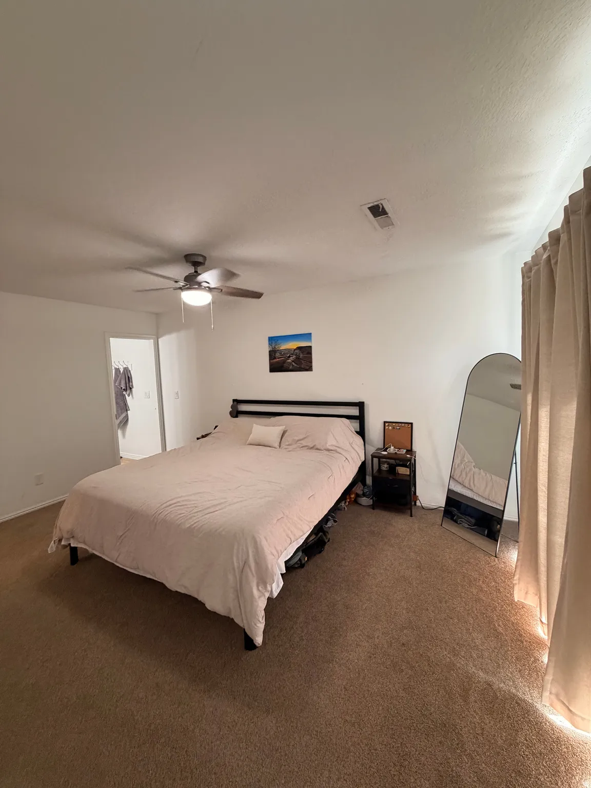 Bedroom featuring dark carpet and ceiling fan