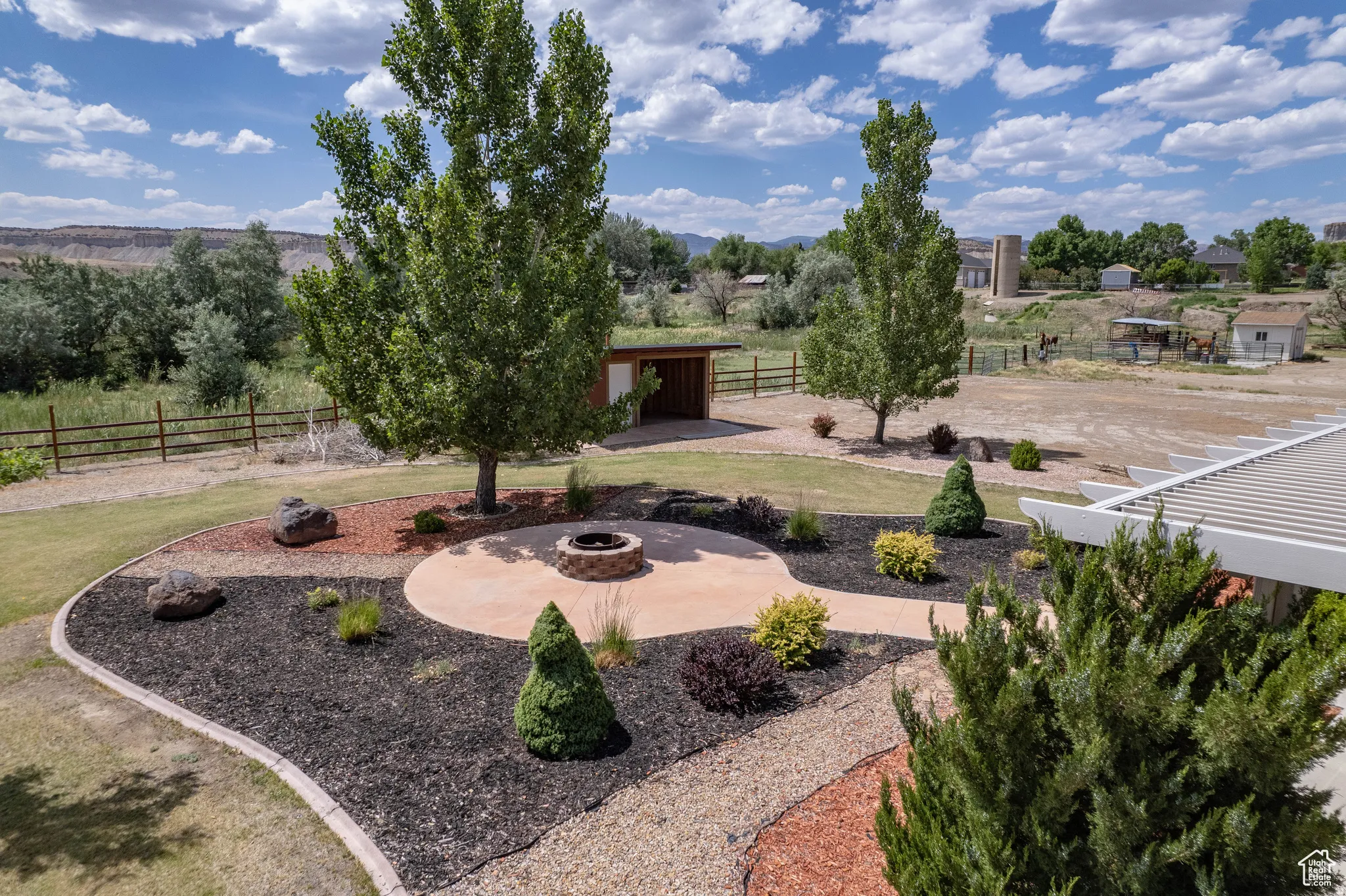 View of yard with an outdoor fire pit and an outdoor structure
