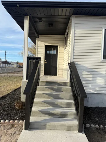 View of exterior entry with a porch