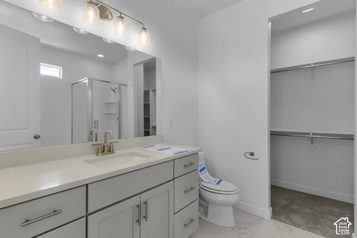 Double vanity with a large mirror, brushed nickel faucet, and under-sink cabinetry