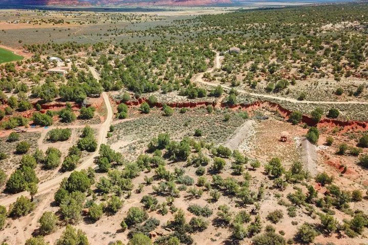 Extensive land featuring varied topography, desert vegetation, and unpaved access roads