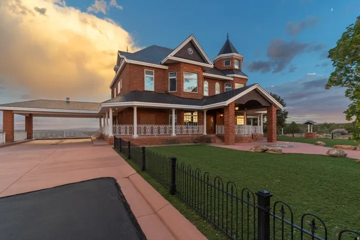 Brick exterior with a prominent turret and a covered porch