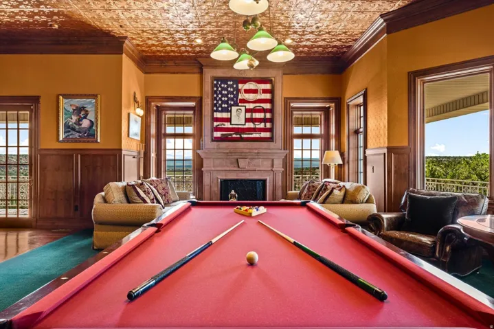 Detailed wood paneling and trim complement the patterned ceiling