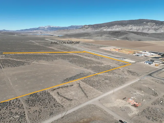 View of rural area with a mountainous background and property boundaries highlighted