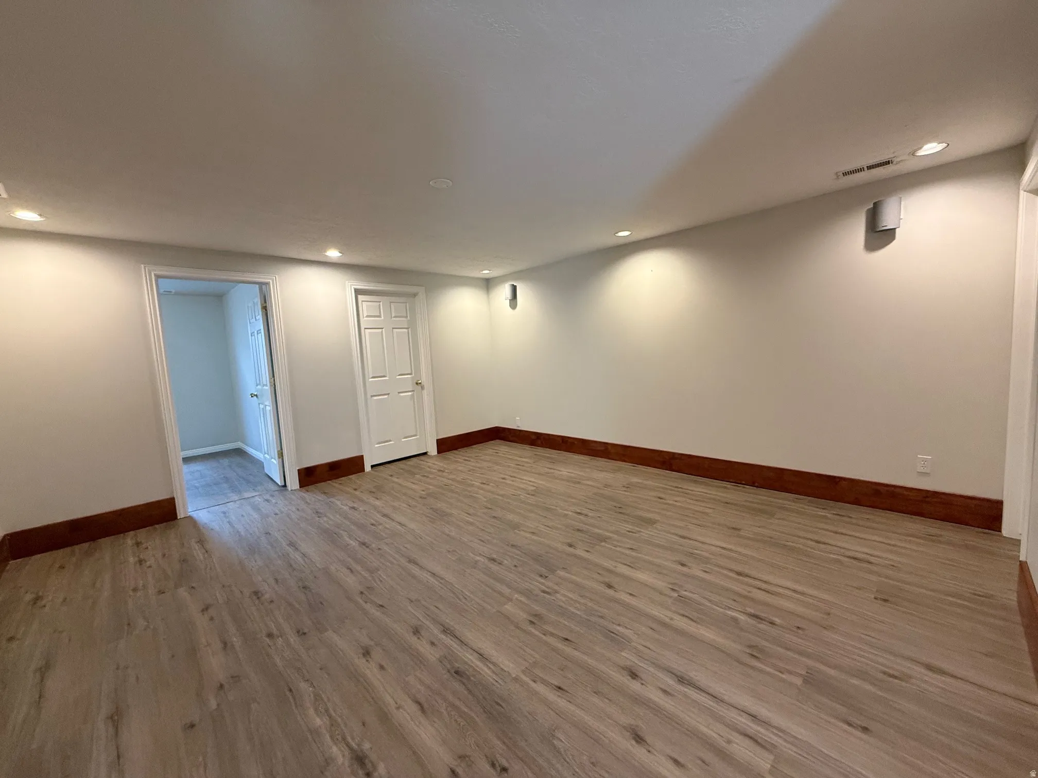 Unfurnished room featuring light wood finished floors and recessed lighting