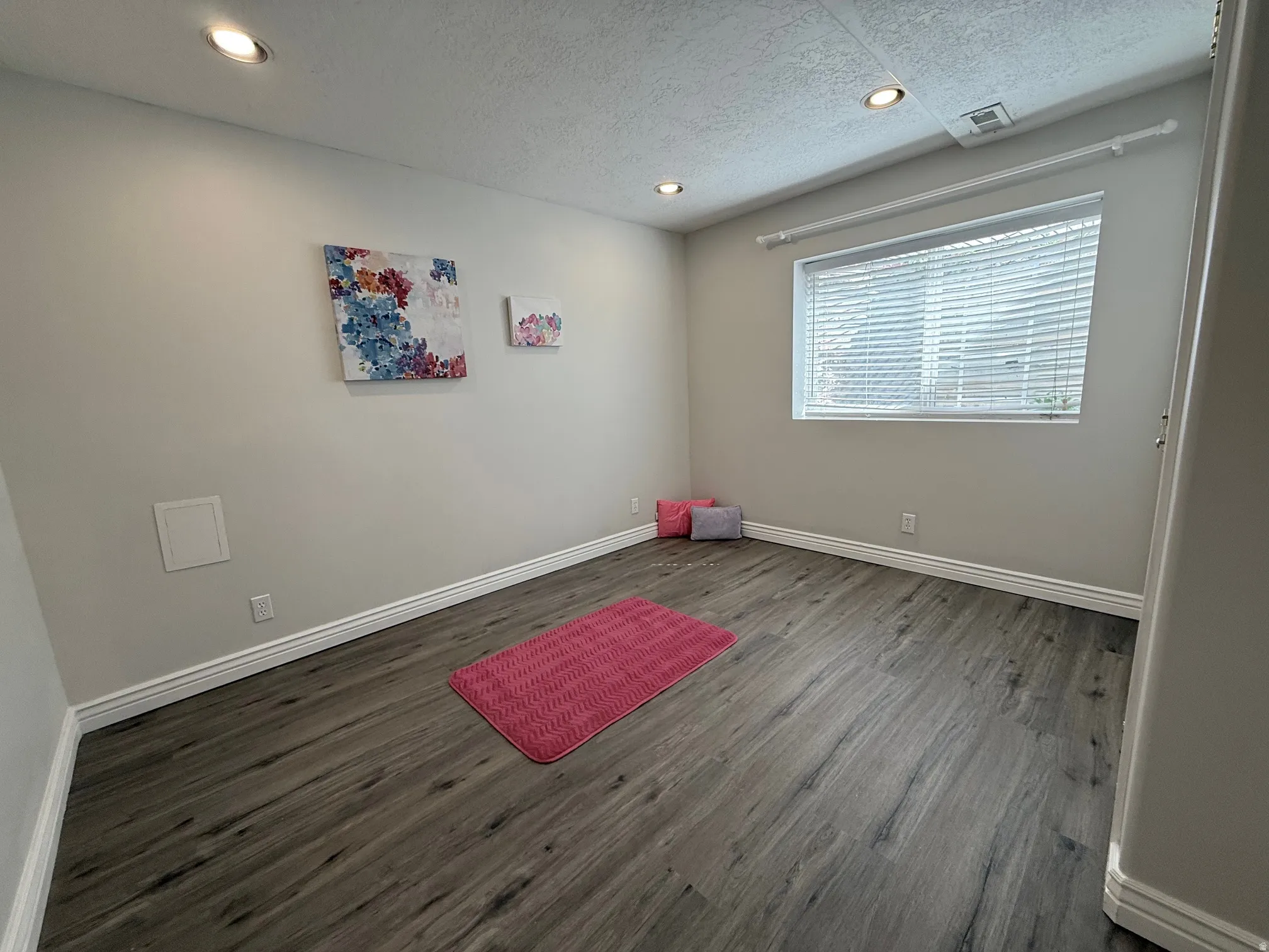 Exercise room with recessed lighting, dark wood-style flooring, and a textured ceiling