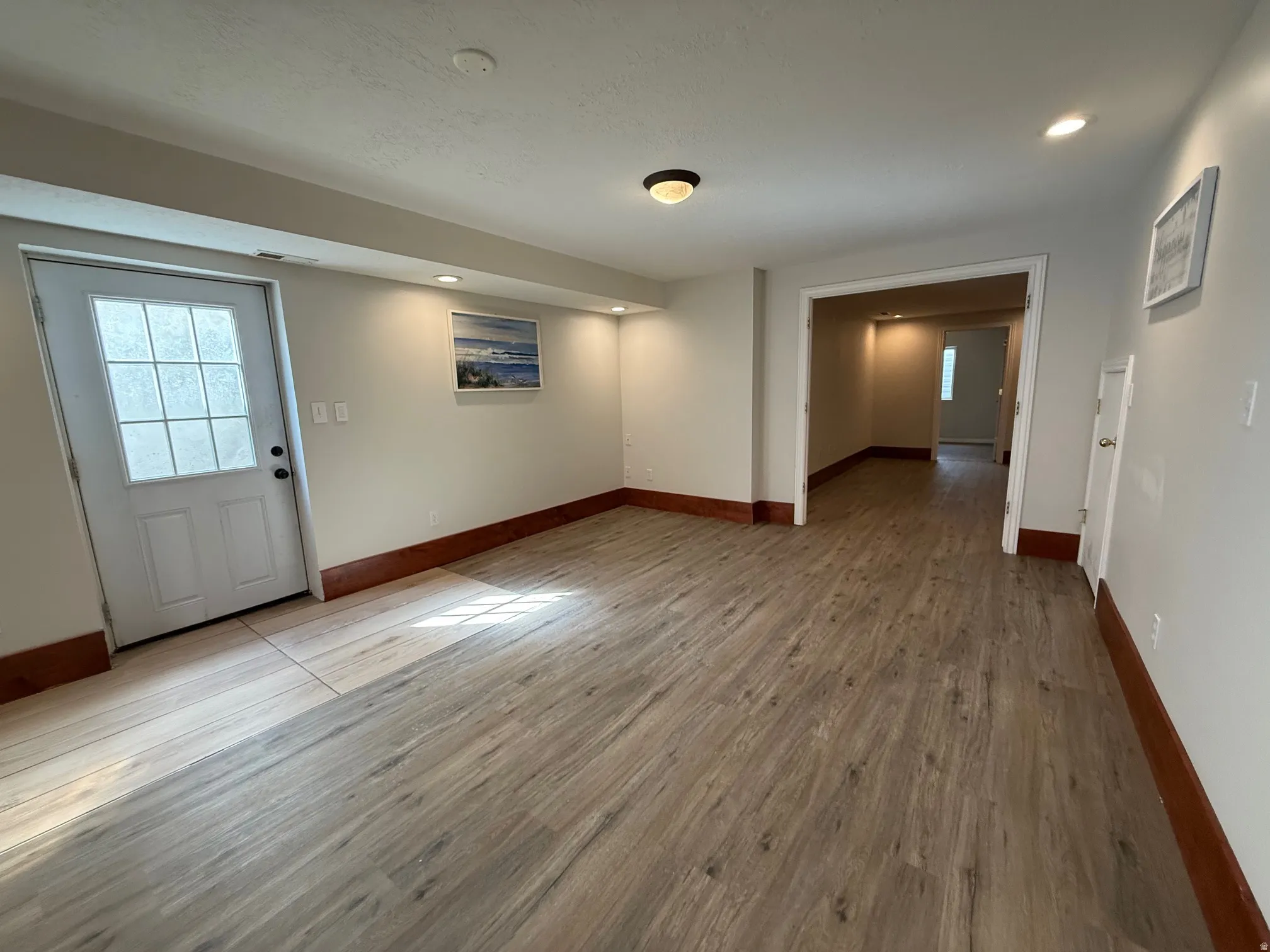 Foyer featuring light wood-style flooring, plenty of natural light, and recessed lighting