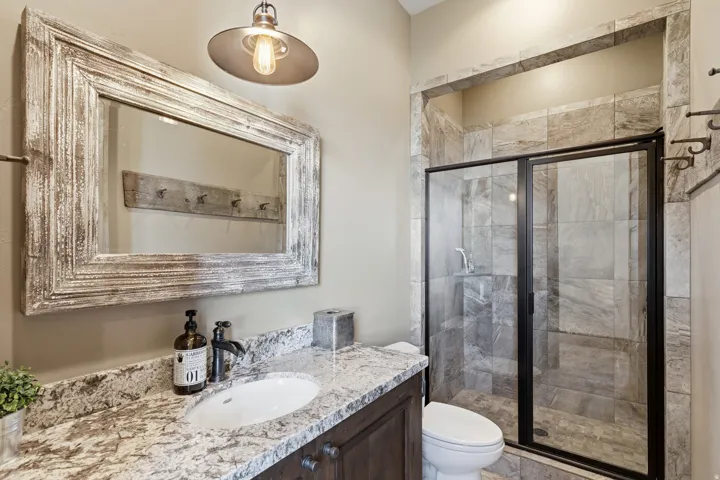 Bathroom featuring vanity and a stall shower
