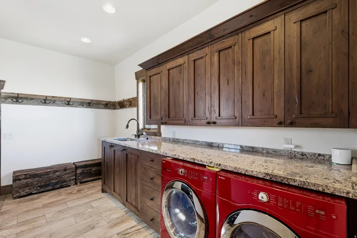 Laundry area with light wood finished floors, cabinet space, washing machine and clothes dryer, and recessed lighting