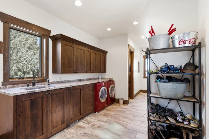 Laundry area with washer and dryer, cabinet space, and recessed lighting