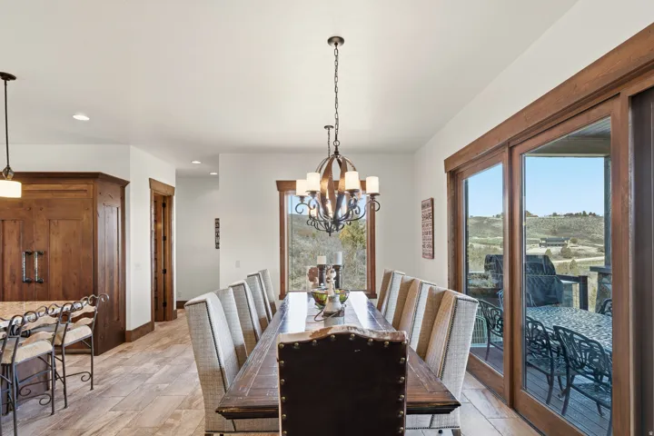 Dining space featuring healthy amount of natural light, light wood-type flooring, and suspended lighting