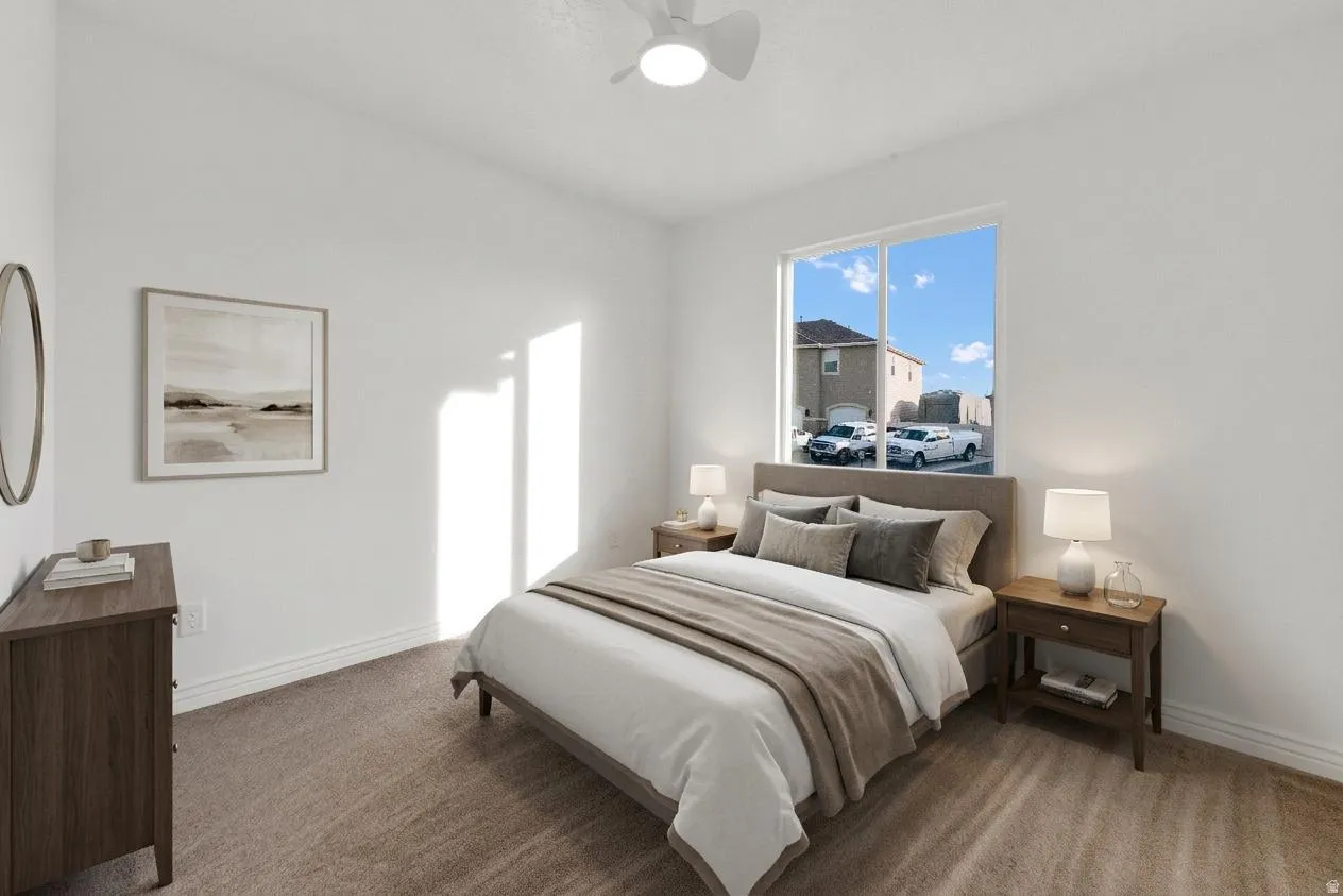 Staged room with Carpeted bedroom with baseboards and ceiling fan
