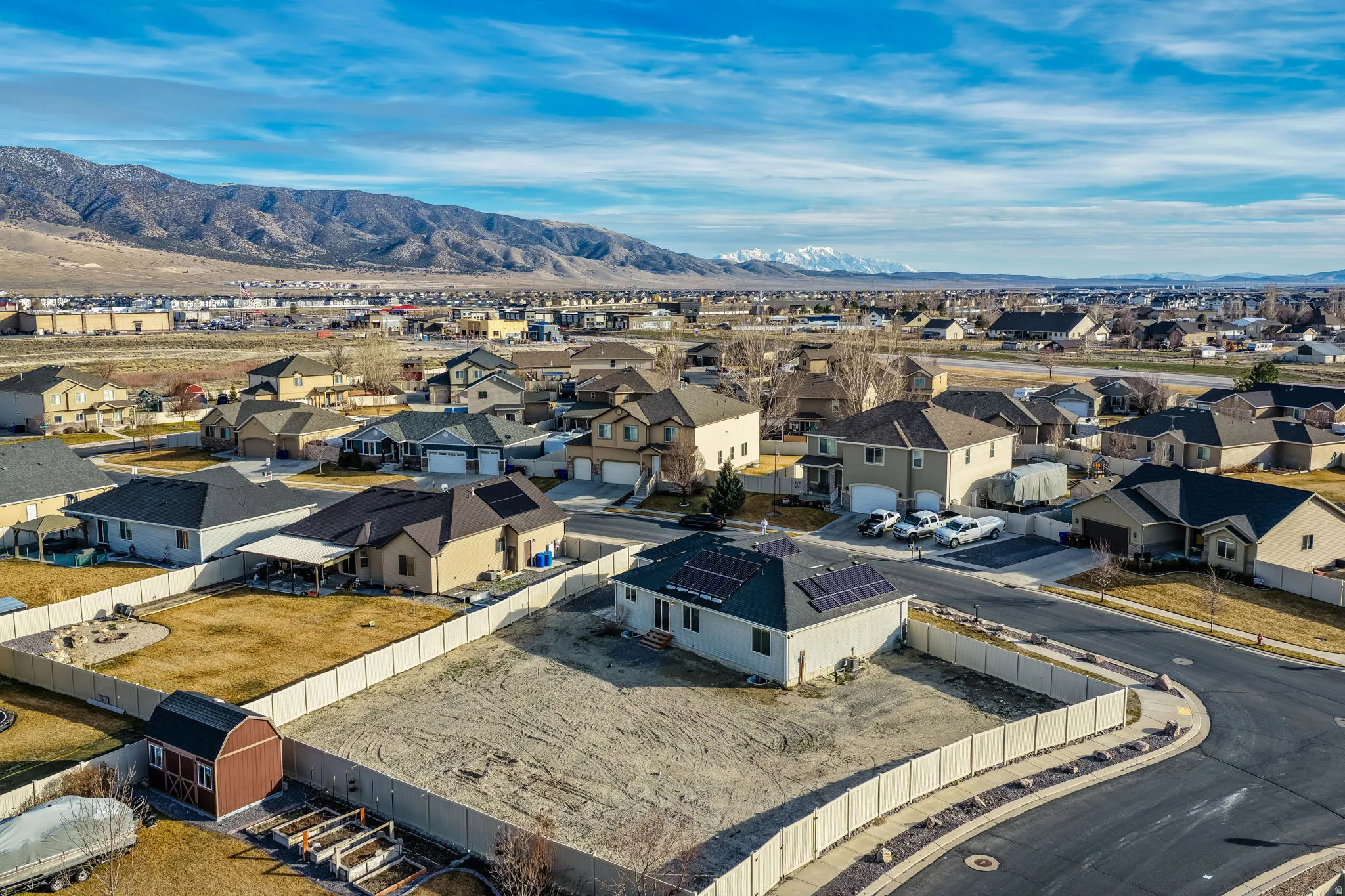 Aerial view of residential area featuring a mountainous background