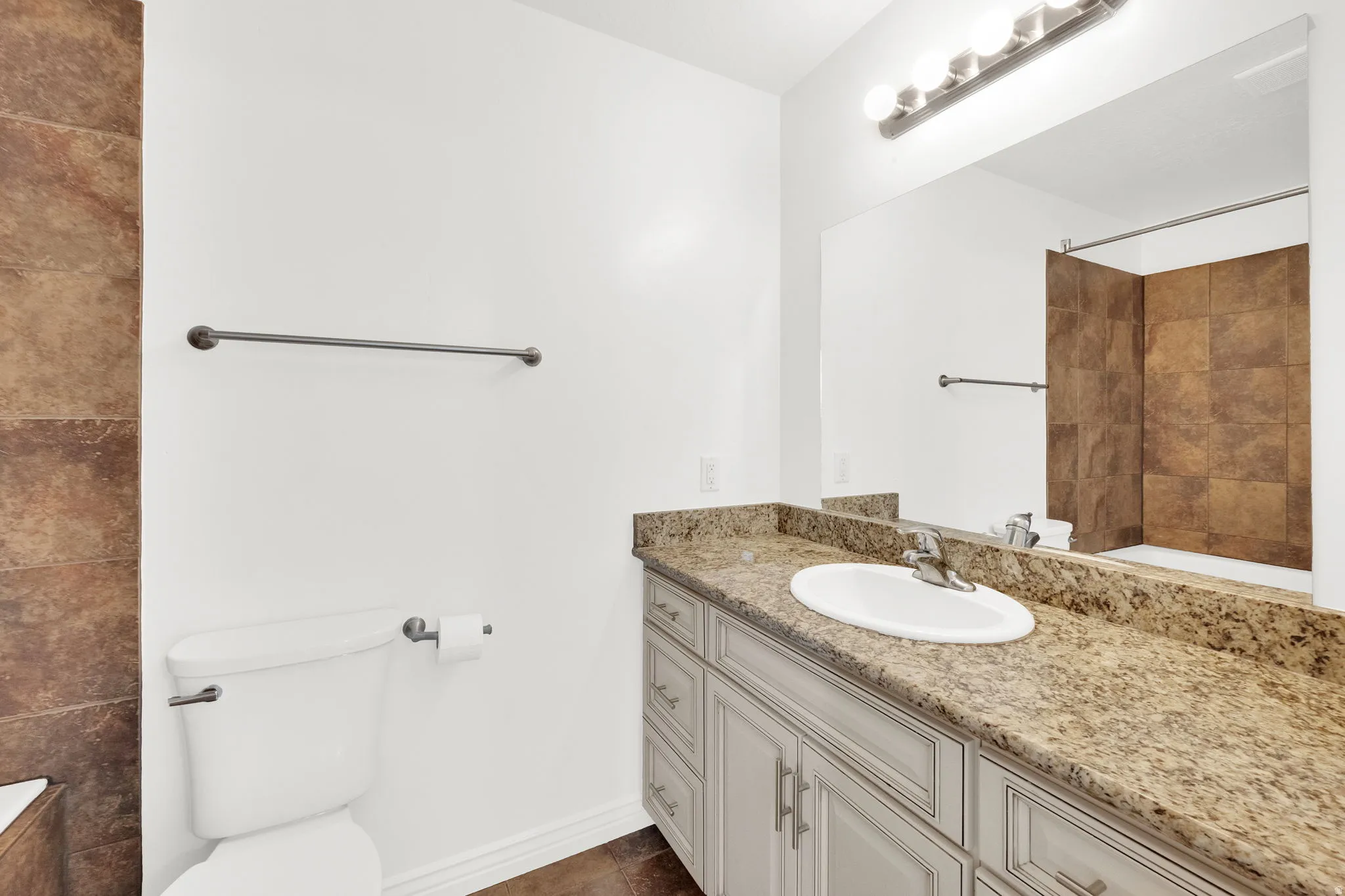 Primary Bathroom with vanity and a tile shower