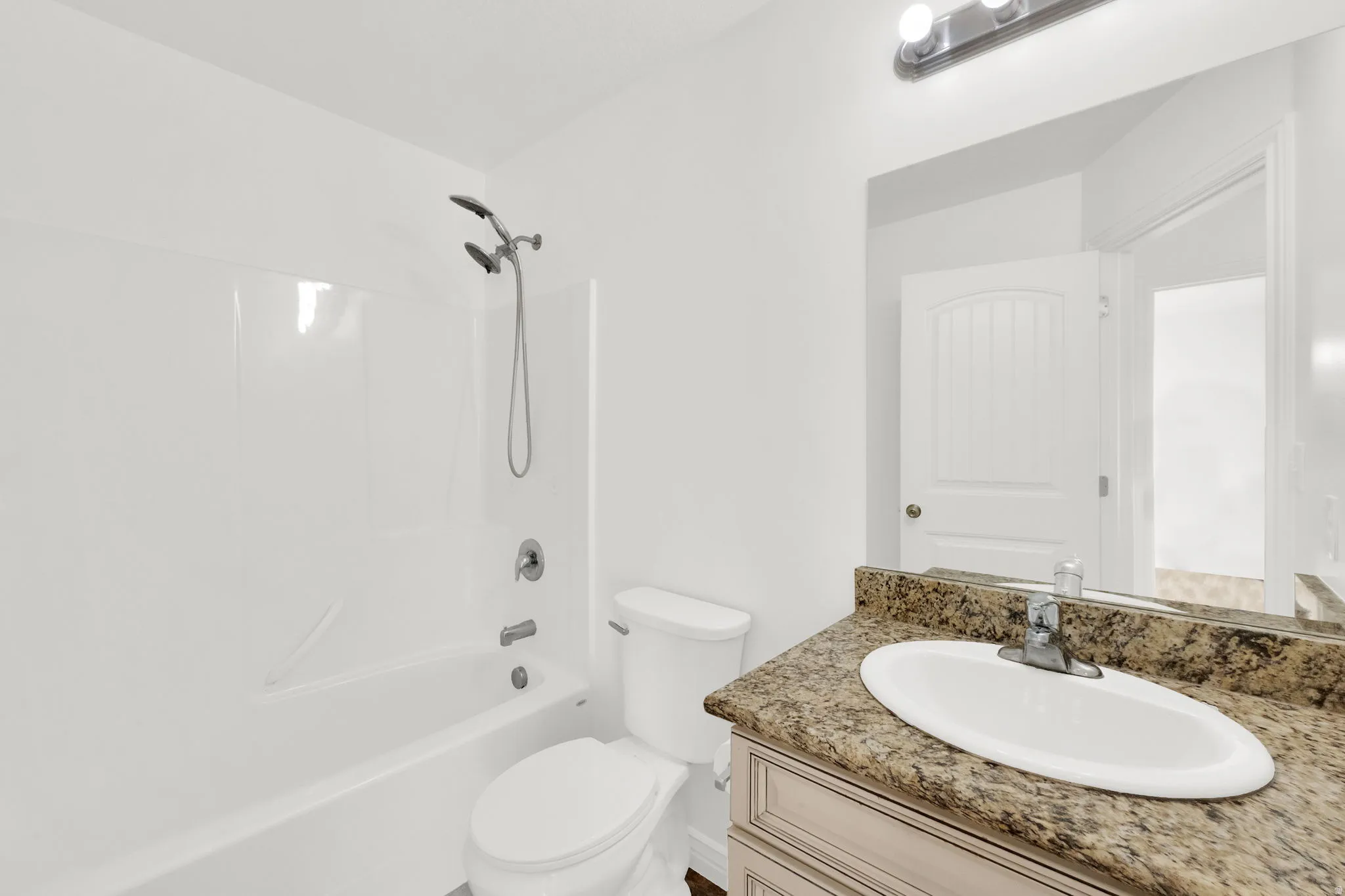 Bathroom with vanity and tub / shower combination