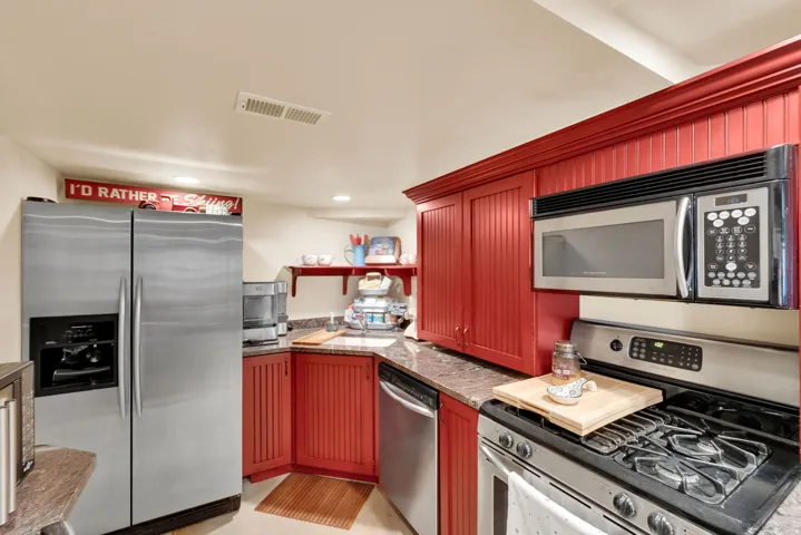Kitchen with stainless steel appliances, recessed lighting, and open shelves