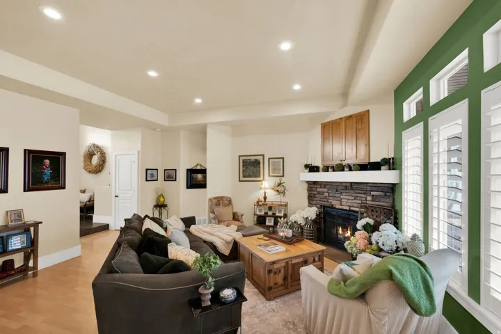 Living area with a fireplace, recessed lighting, and light wood-type flooring