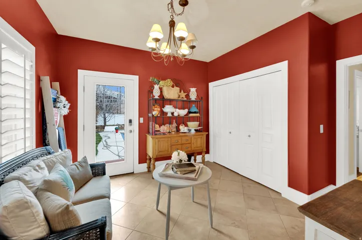 Living area with hanging lights and tile patterned flooring