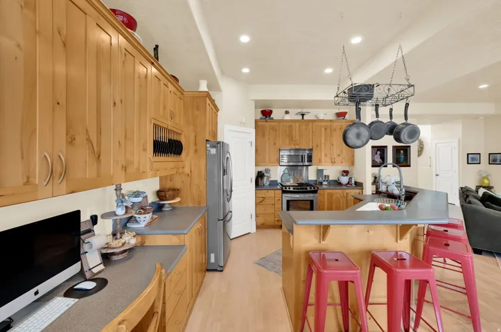 Kitchen featuring a breakfast bar, stainless steel appliances, light wood-style flooring, recessed lighting, and a kitchen island