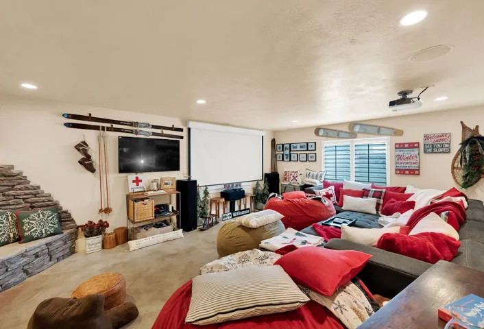 Living area with recessed lighting and carpet floors