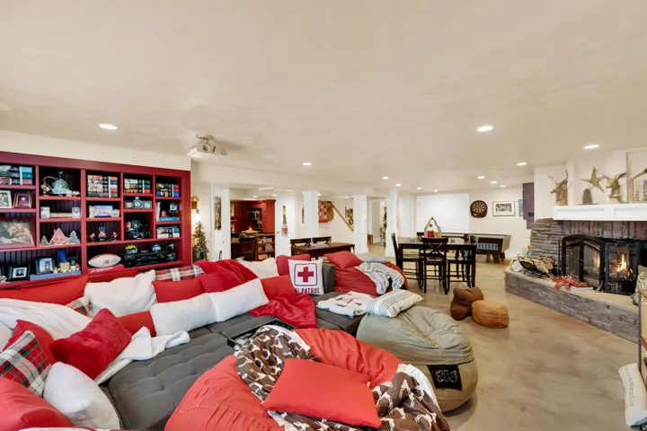 Living area with a fireplace, concrete floors, and recessed lighting