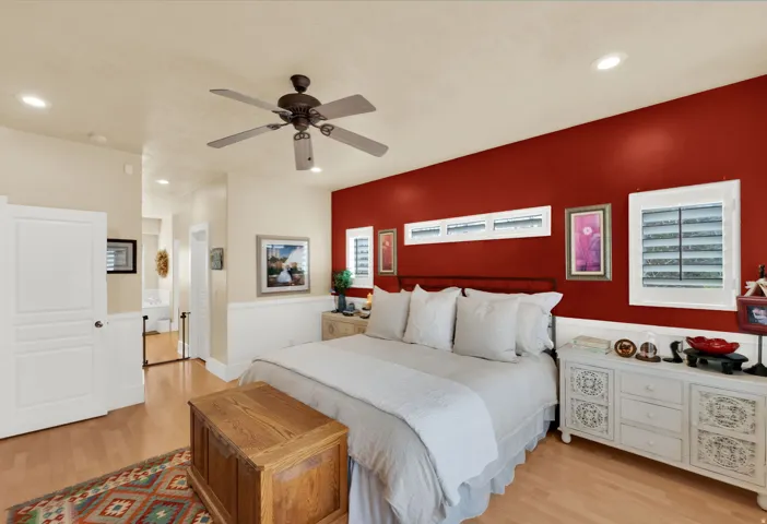 Bedroom with light wood finished floors, a ceiling fan, and recessed lighting