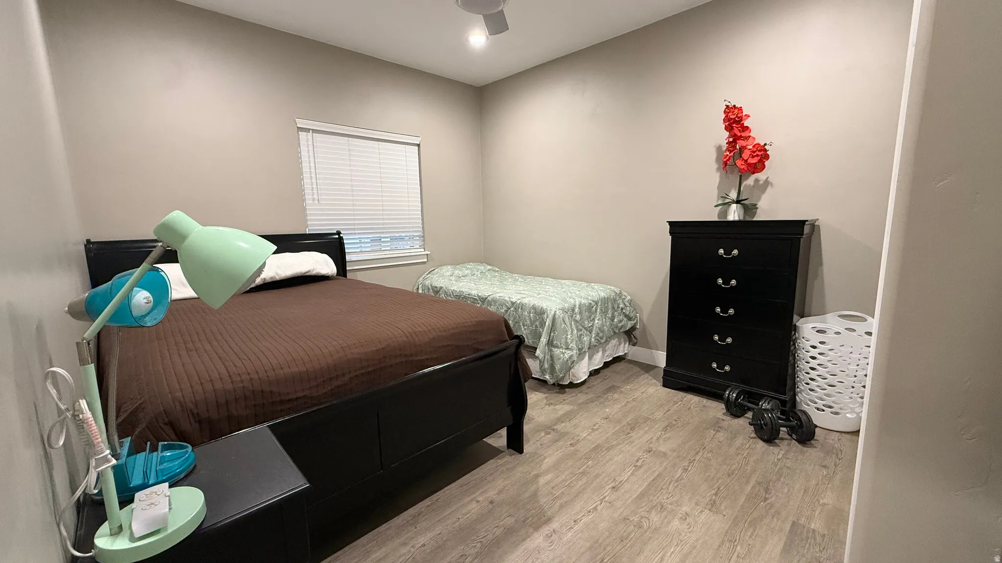 Bedroom with light wood-style floors and ceiling fan