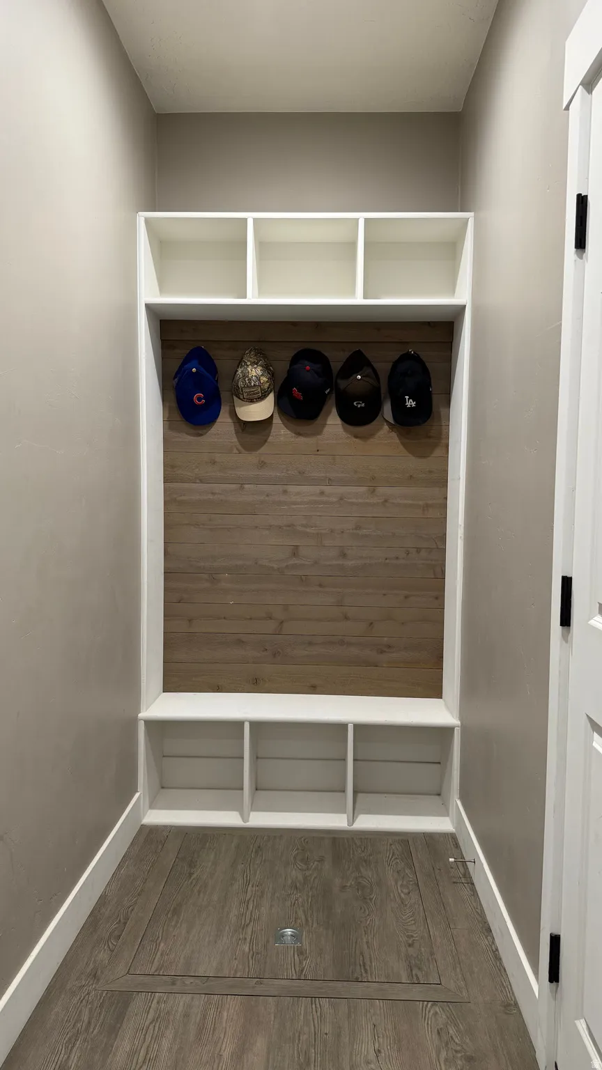 Mudroom featuring dark wood-style flooring and baseboards