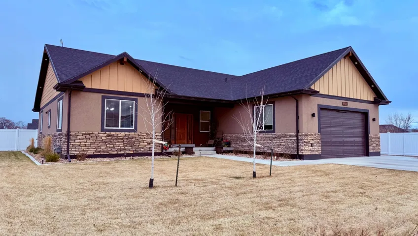 Craftsman inspired home with stone siding, covered porch, an attached garage, a shingled roof, and concrete driveway