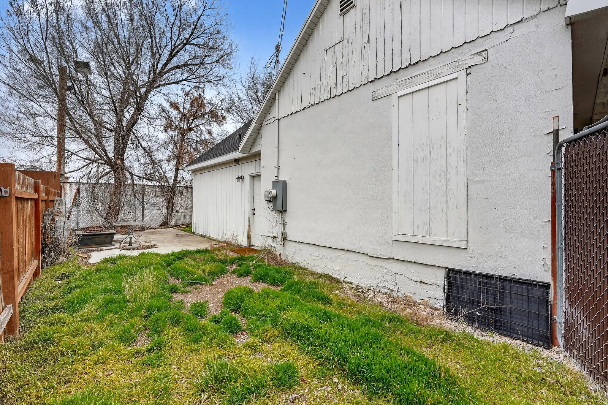 View of property exterior featuring a patio area and a fire pit