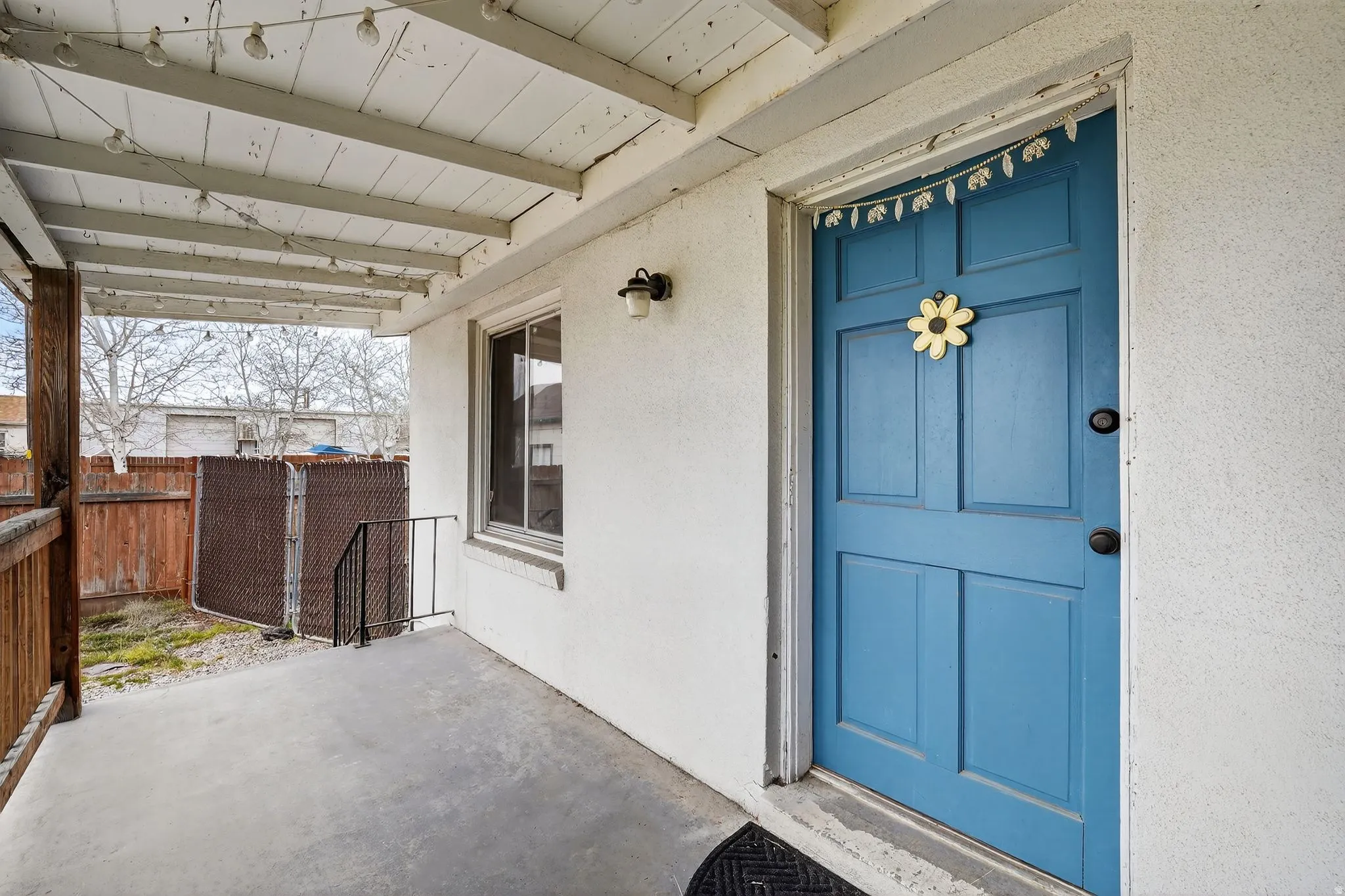 View of exterior entry featuring a patio and stucco siding