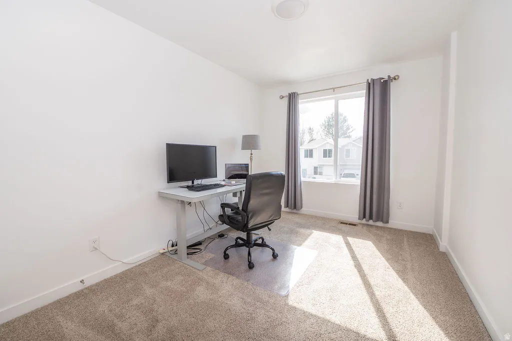 Office featuring baseboards and light carpet