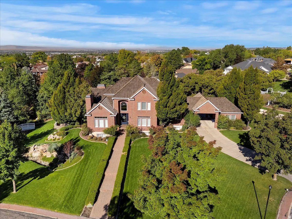 Aerial view of residential area featuring a tree filled landscape