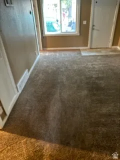Interior space with carpet floors and baseboards