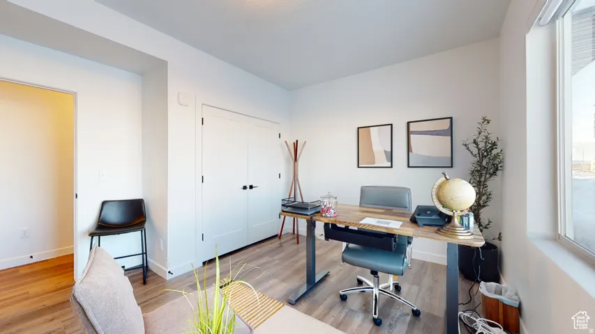 Home office with light wood-style floors